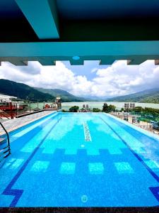 a large swimming pool on top of a building at Hotel Adam in Pokhara