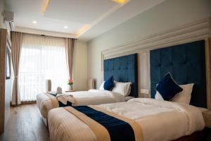 Łóżko lub łóżka w pokoju w obiekcie Hotel Adam