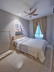 a bedroom with a bed and a ceiling fan at One Life Four Season Waterpark Guest House Manhattan Condominium in Ipoh +130 photos