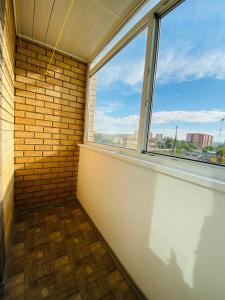 a empty room with a window and a brick wall at 2.х полноценная . ЖК комфорт. in Kokshetau