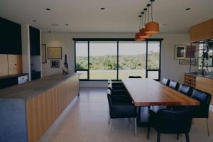 a kitchen and dining room with a table and chairs at Stony Rise Lodge in Robe +31 photos