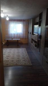 a living room with a table and a television at Casa Mamei in Suceava