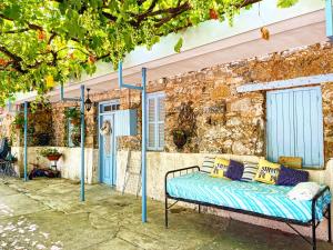 a bed in front of a building with blue poles at Holiday House Prodromos in Prodromos