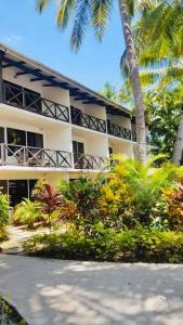a building with palm trees in front of it at Oasis Palms Hotel in Nadi