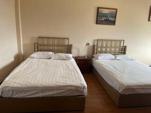a bedroom with two beds and a lamp in it at CHINA STAR HOTEL in Kolonia