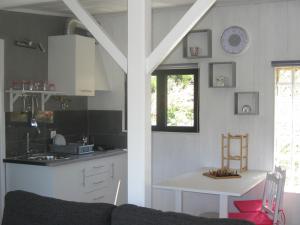 a kitchen with a couch and a table in a room at Cabana do Pinheiral in Ponte da Barca