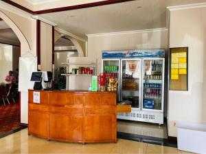 a restaurant with a counter and a drink cooler at CHINA STAR HOTEL in Kolonia