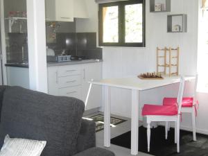 a kitchen with a white table and two chairs at Casa Do Pinheiral in Ponte da Barca