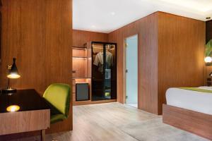 A bed or beds in a room at Ironwood Hotel