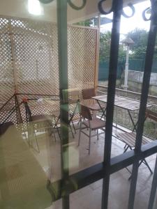 a patio with chairs and tables and a fence at Beldibi Apart Homes in Antalya