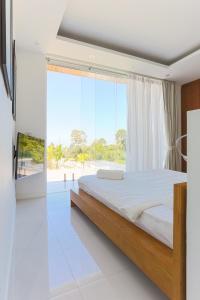 a bedroom with a large bed and a large window at Вилла Vista Del Mare in Koh Samui +61 photos