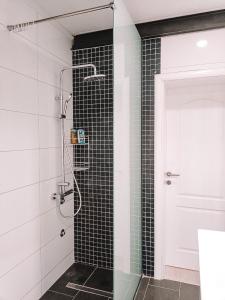 a bathroom with a shower with black and white tiles at Poseidon House in Mostar