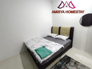 a small bedroom with a bed in a room at Amisya Homestay in Kampung Raja