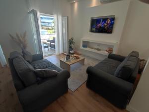 a living room with two couches and a table at Apartman Vlatka 