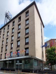 a hotel building with flags on top of it at Eurohotel in Nichelino