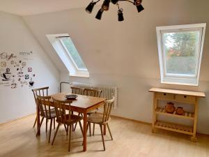 a dining room with a wooden table and chairs at Wohnen am Wasserschloss Sandizell in Schrobenhausen