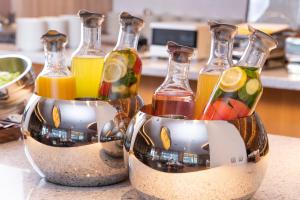 three glass bottles filled with different types of juice at Hotel JAL City Nagoya Nishiki in Nagoya