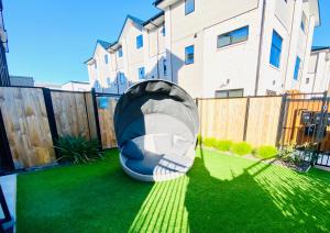 a backyard with a bean bag bed in the grass at CHCH centre Luxury townhouse close to CBD in Christchurch
