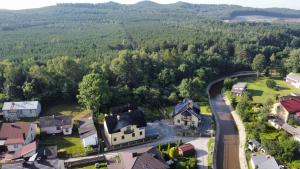 an aerial view of a village with a road and houses at MARMI Noclegi in Golczowice