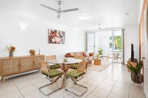 a living room with a table and chairs at Focus on Spence in Westcourt