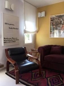 a living room with a chair and a couch at Apartamento renovado en Cadaqués in Cadaqués