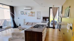 a kitchen and living room with a stove top oven at Bella Vista Lux Apartment with private Terace in Koper +26 photos