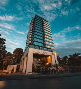 a tall building with a sign in front of it at Carmel Hotel in Ramallah