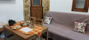 a living room with a table and a couch at ΚΑΦΕΝΕΣ in Kavoúsion