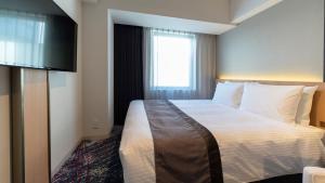 เตียงในห้องที่ Hotel JAL City Nagoya Nishiki