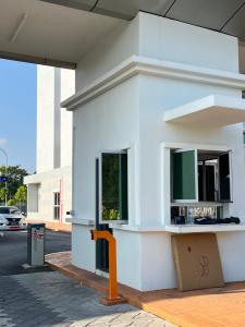 a white building with an orange pole in front of it at Residensi Afamosa in Kampong Alor Gajah