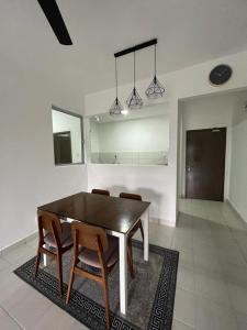 a dining room with a table and some chairs at Residensi Afamosa in Kampong Alor Gajah