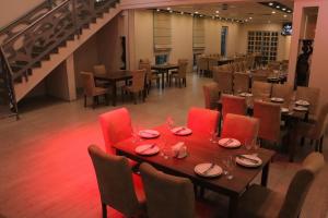 a dining room with a table and chairs and a staircase at Avangard in Batumi