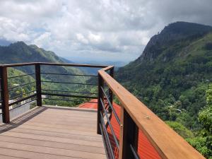 a wooden balcony with a view of a mountain at Ella Mount View Guest Inn in Ella