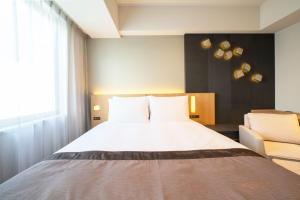 เตียงในห้องที่ Hotel JAL City Nagoya Nishiki