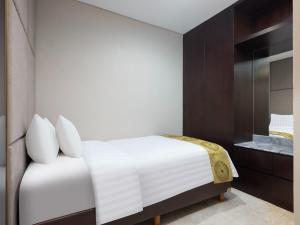 Postelja oz. postelje v sobi nastanitve The Grove Suites by Grand Aston