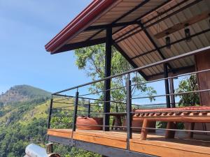 a cow sitting on the deck of a building at Ella Mount View Guest Inn in Ella