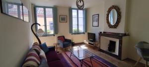 a living room with a couch and a fireplace at The Apartments, Rue Barbès in Carcassonne