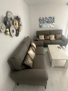 a living room with a couch and a coffee table at 5 minutes à Pied du Stade De France in Saint-Denis