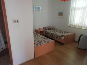 Postel nebo postele na pokoji v ubytování Apartmani Kolenić
