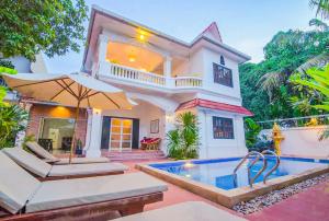 a house with a swimming pool in front of a house at Ravoeun Angkor Boutique in Siem Reap