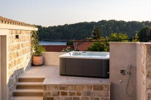 a bath tub sitting on top of a patio at Holiday Home Nico's in Cavtat