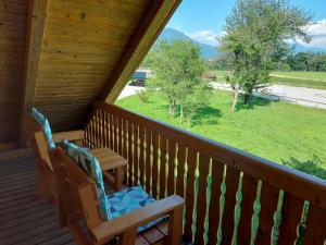 a porch with two chairs and a table on it at Apartma Markelj in Radovljica