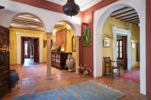 a living room with orange and yellow walls at Hacienda el Burgo in Mairena del Aljarafe