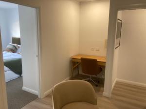 a room with a desk and a chair and a bed at Kincaid@230 in Wagga Wagga