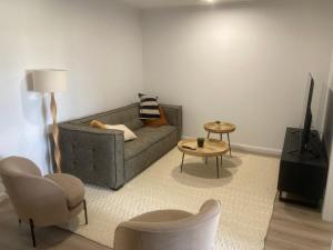 a living room with a couch and a table and chairs at Kincaid@230 in Wagga Wagga