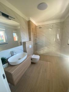 a bathroom with a sink and a toilet and a shower at Guest House Ana Residence in Zadar +28 photos