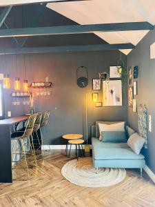 a living room with a couch and a bar at Villa - Stilvolles Boutique Landhaus in Grömitz