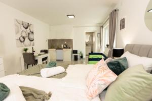 a living room with two beds and a kitchen at apartmani SUN & MOON in Bjelovar