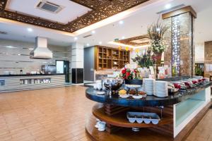 a buffet in a hotel lobby with food on a table at Galina Hotel & Spa in Nha Trang