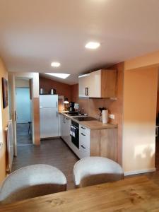 a kitchen with white appliances and a table and chairs at Casa Mediteran NEU in Reichensachsen